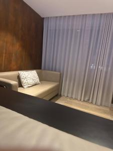 a living room with a couch and a window at Ronza in Abidjan