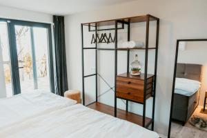 a bedroom with a white bed and a wooden dresser at Cozy Home - Klet Matija in Novi Marof