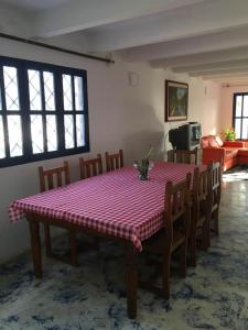 a dining room table with a red and white checkered table cloth at CASAMARAZUL Beach house in Santa Marta +7 photos