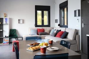 a living room with a table and a couch at Point of View Andromeda in Drymon +14 photos