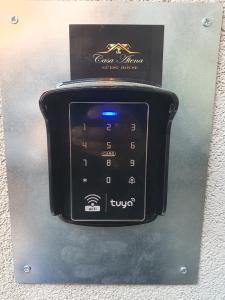 a close up of a cell phone on a wall at Casa ATENA in Villa dʼAlmè