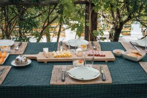 a table with a green table cloth with food on it at Fount Estremiero - Chambres & tables d'hôtes in Castans