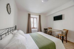 Postel nebo postele na pokoji v ubytování La Cattedrale Rooms + 29 fotografií