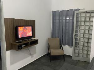 a room with a tv and a chair and a window at 739 Casa 1 · Casa1 - 2 dorm, otima local ,Wi-Fi,Note,Gar, pet in Campinas +15 photos