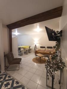 a living room with a couch and a table at Gîtes Le Meslaysien in Meslay-du-Maine +26 photos
