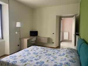 a bedroom with a bed and a desk with a television at Holiday Home in Belmonte del Sannio