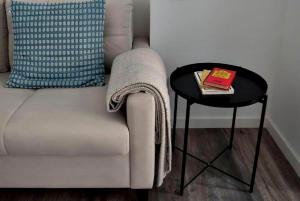 a chair and a table with a book on it at Apartments Central Madrid - q2home in Madrid
