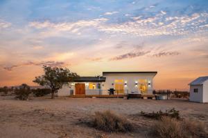 a small house in the middle of a field at Shangrila By The Cohost Company in Joshua Tree
