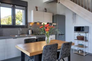 a kitchen with a wooden table with a vase of flowers on it at Point of View Cassiopeia in Drymon +17 photos