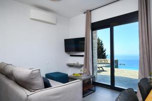 a living room with a couch and a view of the ocean at Point of View Cassiopeia in Drymon