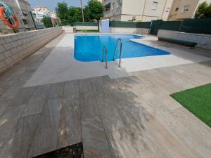 a swimming pool in the middle of a building at SPACIOUS FLAT 100M FROM BEACH-NERJA-Spain in Nerja