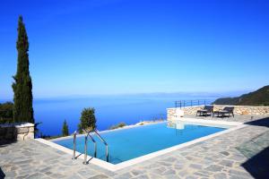 a swimming pool with a view of the water at Point of View Cassiopeia in Drymon