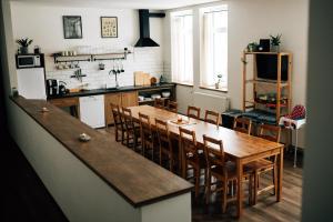 a kitchen with a large wooden table and chairs at Chata Horalka in Jáchymov
