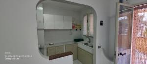 a kitchen with a sink and a mirror in a room at La Pergola Apartments in Lampedusa +112 photos