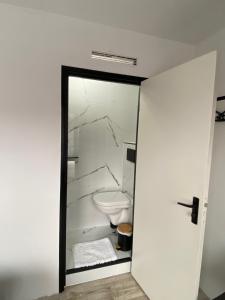 a white bathroom with a toilet in a room at Amsterdam Soul Inn in Amsterdam