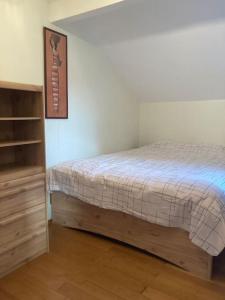 a bedroom with a bed and a book shelf at Le lit de la Semois in Vresse-sur-Semois