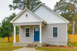a small white house with a blue door at 3 Mi to Dtwn Home with Patio and Grill in New Bern in New Bern
