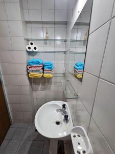 a white bathroom with a sink and a mirror at En la cañada cerca de todo in Córdoba +12 photos