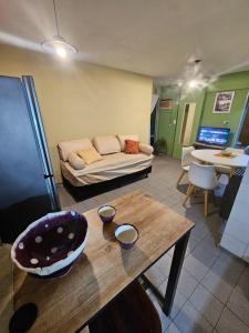 a living room with a couch and a table at En la cañada cerca de todo in Córdoba