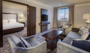 a hotel room with a bed and a living room at Glasgow Grosvenor Hotel in Glasgow +29 photos