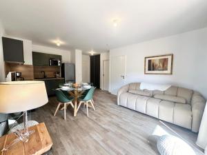 a living room with a couch and a table at Résidence Le Living Stone B - PARKING-PROCHE PISTES-COEUR DE STATION-Tout inclus MAE-7981 in Vars +6 photos