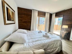 a bedroom with a large bed and a large window at Résidence Le Living Stone B - PARKING-PROCHE PISTES-COEUR DE STATION-Tout inclus MAE-7981 in Vars