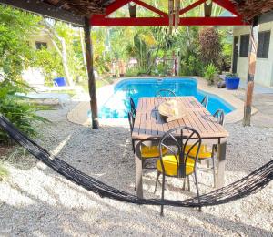 a table and chairs in a hammock next to a pool at Travellers Motel Vanuatu in Port Vila