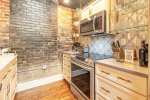 a kitchen with a brick wall and a stove at 80 Lex 203 Eclectic Industrial Apt in Asheville +25 photos