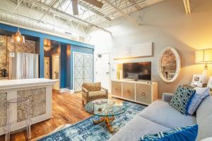 a living room with a couch and a table at 80 Lex 203 Eclectic Industrial Apt in Asheville