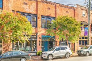 two cars parked in front of a brick building at 80 Lex 203 Eclectic Industrial Apt in Asheville