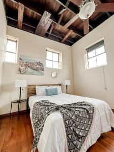 a bedroom with a large bed and two windows at Sleepover 2BD 1BA Condos Downtown Springfield in Springfield