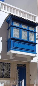 a building with blue windows and a blue door at Sea Esta Guest House in Mellieħa +90 photos