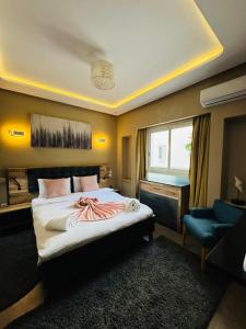 a bedroom with a large bed and a blue chair at Marina Panorama Apartement in Agadir