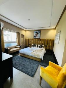 a hotel room with a bed and a couch at Marina Panorama Apartement in Agadir