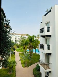 an apartment building with a walkway next to a resort at Marina Panorama Apartement in Agadir