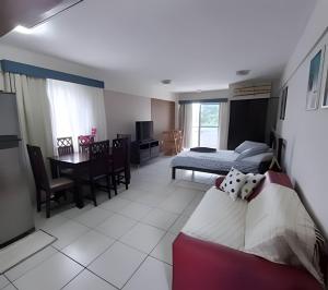 a living room with a bed and a dining room at MoviHosts Terrazzo in Natal