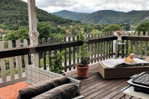 a dog is sitting on a bed on a deck at Mountains Apartment Elb Canyon in Ústí nad Labem