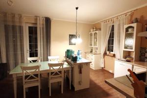 a kitchen with a table and some chairs and a table and a counter at Mountains Apartment Elb Canyon in Ústí nad Labem