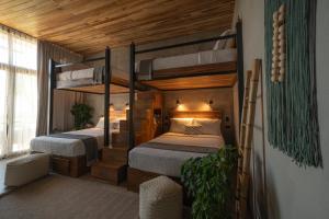 a bedroom with two bunk beds in a room at Surf Synergy All-Inclusive Surf and Wellness Retreat in Jacó +72 photos