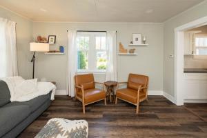 a living room with a couch and two chairs and a table at Charming Cozy Cottage with Hot Tub in Coeur d'Alene