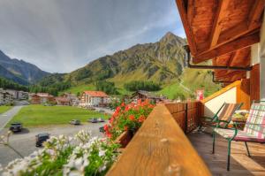 a balcony with a view of a mountain at Country Wellnesshotel Bündnerhof in Samnaun
