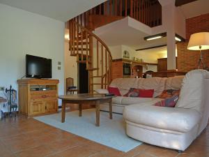 a living room with a couch and a table at Spacious holiday home by the river in Le Boulou