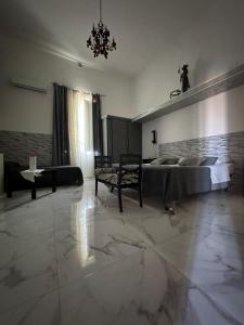 Un dormitorio grande con una cama y un sofá. en B&B Camelot, en Palermo