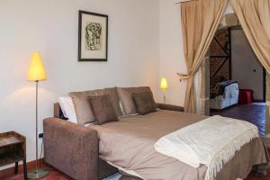 a bedroom with a large bed and a couch at Antica Cantina Emilia in Reggio Calabria