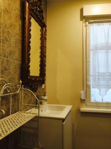 a bathroom with a sink and a mirror and a window at Villa Kleber in Strasbourg