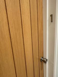 a wooden door with a silver door knob at Luxe Comfort En-Suite Room 1 in Oxford