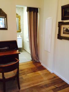 a hallway with a piano and a door to a room at Villa Kleber in Strasbourg +3 photos
