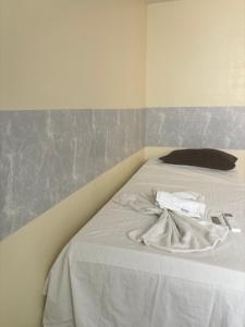 a white bed with towels on it in a room at H one Hotel in Goiânia +31 photos
