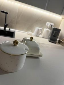 a white cup sitting on top of a counter at Urban Apartman-privatan parking- in Kraljevo