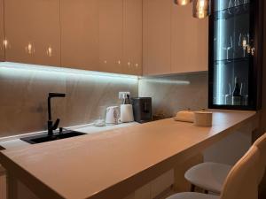 a kitchen with a sink and a counter top at Urban Apartman-privatan parking- in Kraljevo